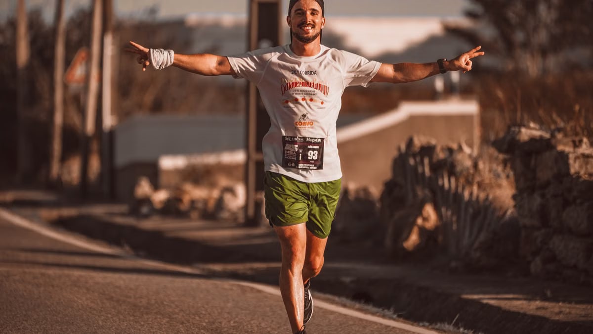 Smiling runner enjoys the thrill of a marathon on a sunny day outdoors.